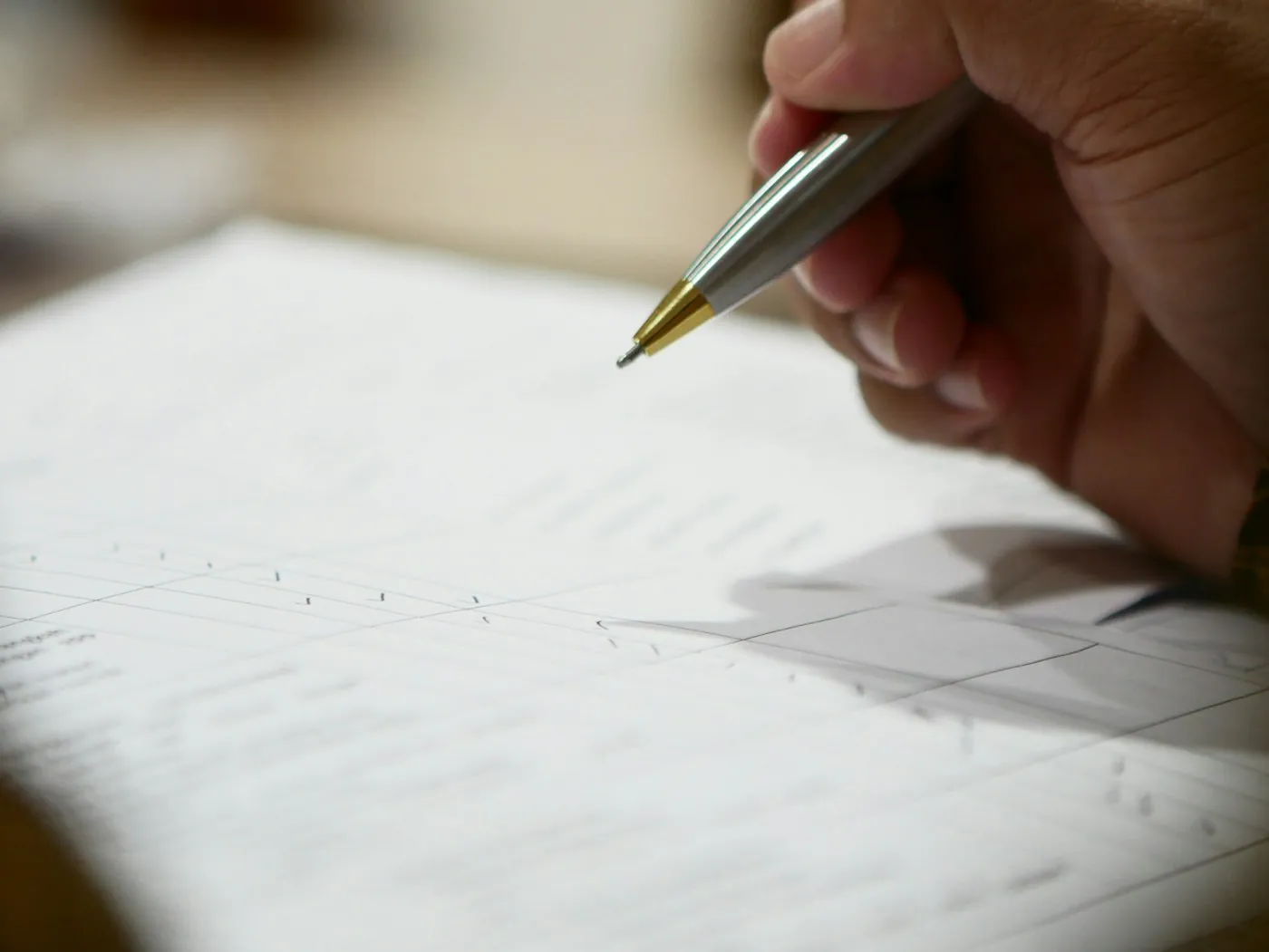 Mão assinando um documento